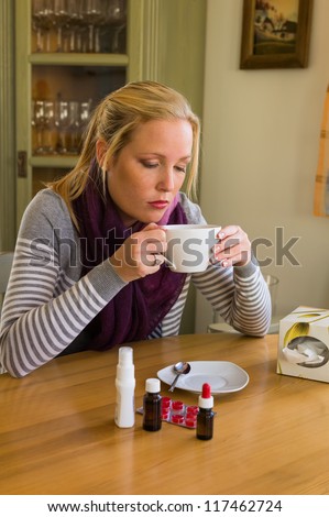 woman on sick leave with tea and medicines. cold, cold and flu season