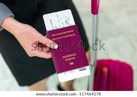 businesswoman with passport, luggage and flight ticket at the airport. business trip