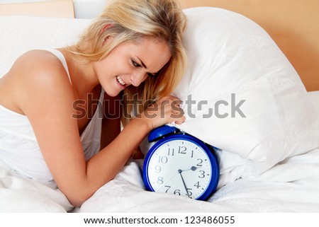 insomnia with clock in the night. woman can not sleep.