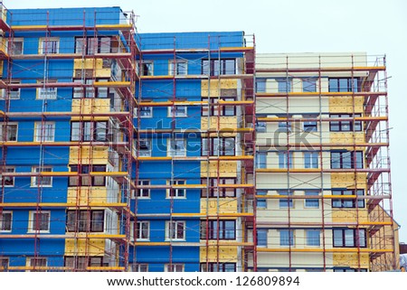 a residential building is being renovated. for energy saving insulation and heat protection.