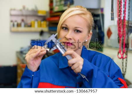 an apprentice (apprentice) in the metal industry. measure a workpiece in the workshop. rare female occupations