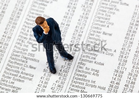 a small figure and the prices of shares in the newspaper. earn money on the stock market. gains and losses in stock trading.