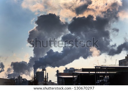 chimney of an industrial company with smoke. symbolic photo for environmental protection and ozone.