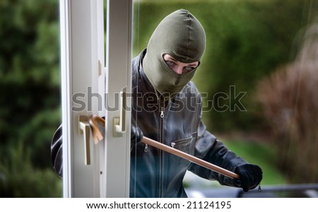 Burglar breaks into a residential building.
