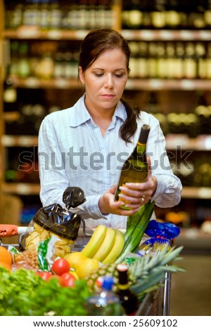 Young woman in a supermarket to buy wine