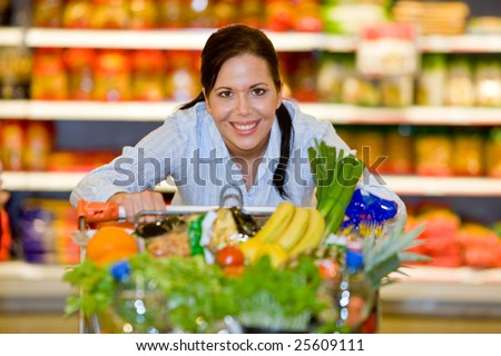 Young woman in the supermarket to buy food and a fruit