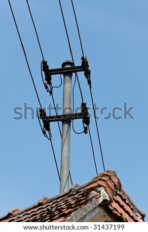 Electricity and telephone cable carrier on a house roof mounted