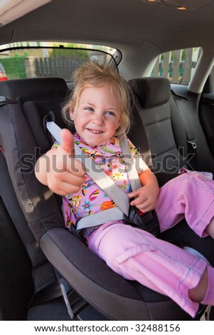 Small child seated in child seat in the car