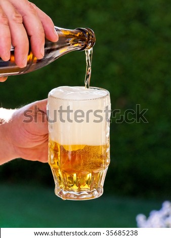 Fresh beer from a beer bottle beer glass is poured