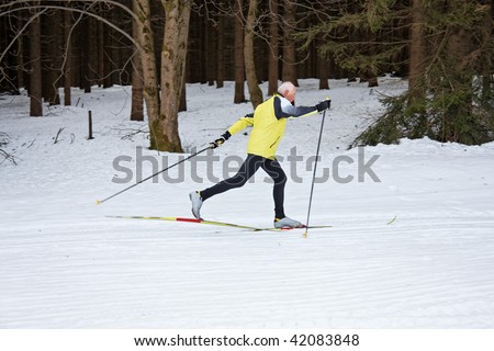 Senior in winter to cross country skiing on snow skis