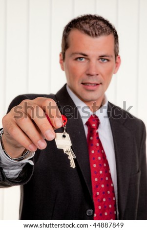 Successful real estate broker with a house key