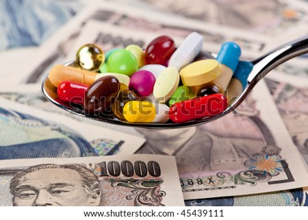 Tablets and Japanese Yen currency symbol for health costs