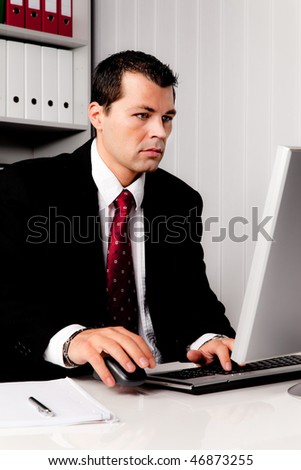 Young businessman in office with computer