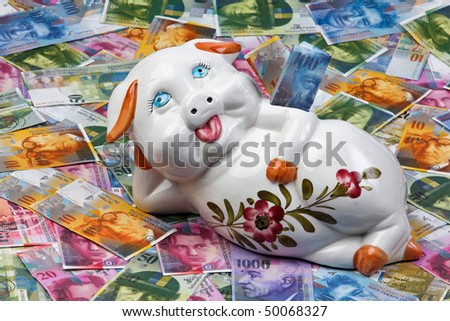 A funny piggy bank is located in Swiss francs