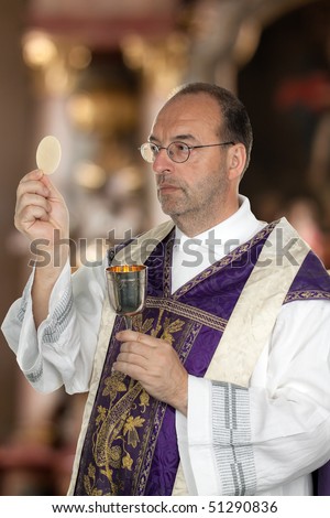 A Catholic priest in the Communion in worship in the church