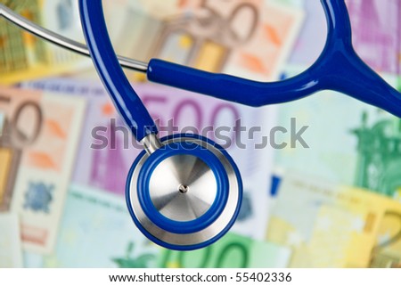 Many Euro bank notes with a stethoscope. Health costs.