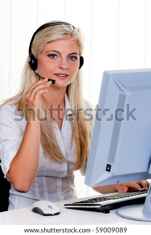 Young Woman with a headset and computer at Hotline.