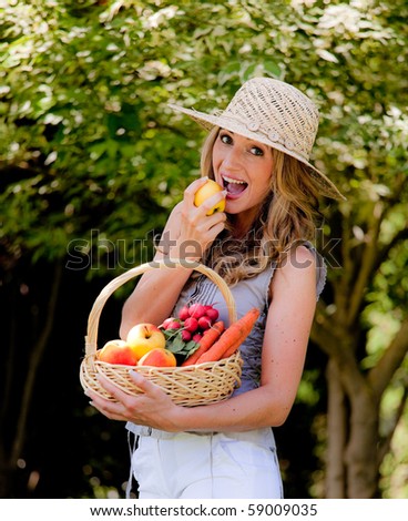 Young woman with fruit and vegetables in the basket
