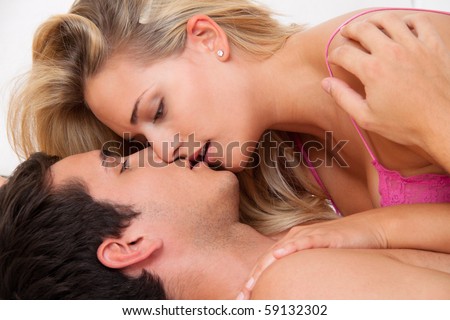 Couple in bed with sex and affection. Love and eroticism in the bedroom.