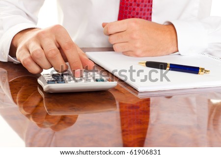 Businessman with a calculator. Calculation of costs, revenues, balance sheet