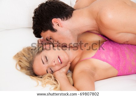 Couple in bed with sex and affection. Love and eroticism in the bedroom.