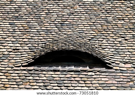 Roof shingles on an old house. Old roof covered with tiles