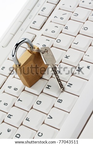 A lock and key is on a computer keyboard. Data Security
