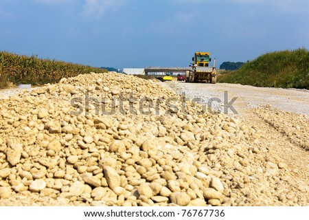 Site with an excavator at the construction of a new road
