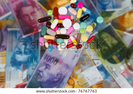 Swiss francs and tablets as a symbol of health costs