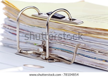A file folder with documents and papers. Retention of contracts.