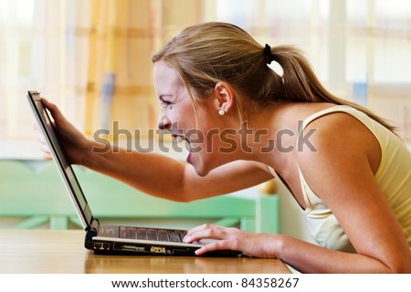 A woman angry over your computer. Problems with hardware, software and Internet shopping