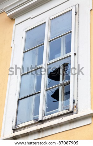 a window with a broken window pane. broken glass.