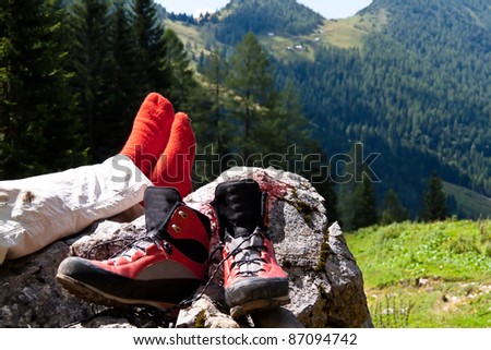 red hiking boots for a hike in the mountains of austria. activity in leisure time