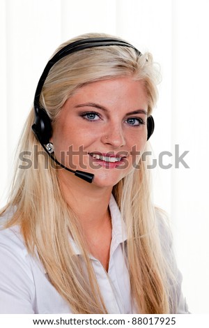 young woman with telephone headset in a call center