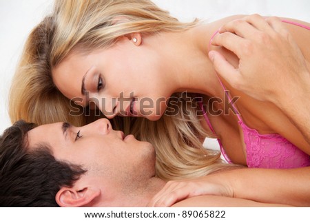 a young couple has fun and joy in bed