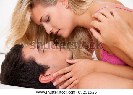 couple in bed during sex and tenderness. love and eroticism in the bedroom.