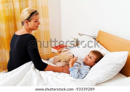 a mother and sick child in bed. influenza. childhood diseases.