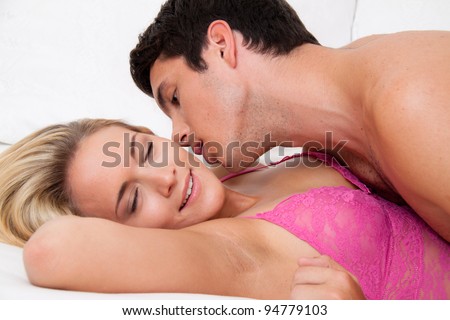 couple in bed during sex and tenderness. love and eroticism in the bedroom.