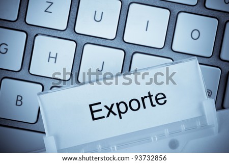 the one hanging folder tab before a computer keyboard on exports
