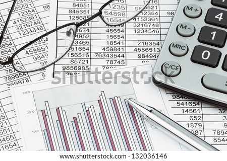 a calculator is on a balance sheet numbers are statistics photo icon for sales profit and cost a calculator is on a balance sheet numbers are statistics photo icon for sales profit and cost