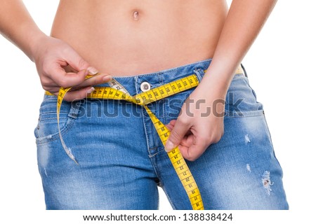 a young woman with a tape measure before the next diet. losing weight and fast