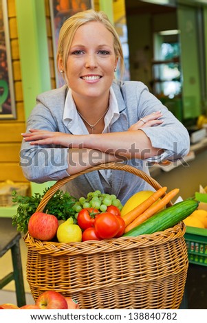 a young woman buying fruits and vegetables at a weekly market. fresh and healthy diet.
