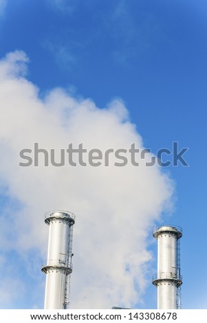 chimney of an industrial company a wake smoke. symbolic photo for environmental protection and ozone.