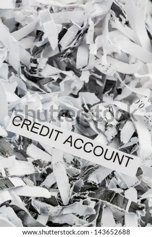 shredded paper tagged with credit account, symbolic photo for data destruction, finance and credit