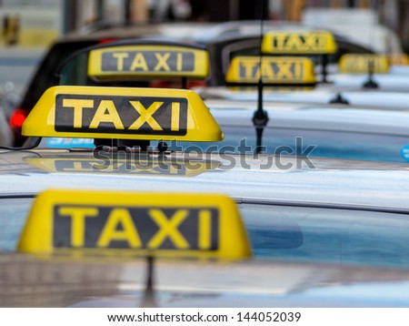 taxis wait at a taxi rank, symbol photo for passenger transport and services