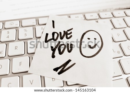 a sticky note on the keyboard of a computer is to remember: i love you
