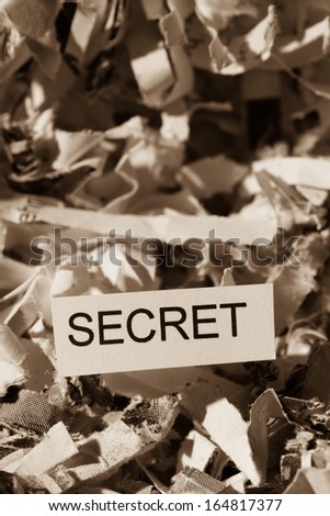 shredded paper tagged with secret, symbol photo for data destruction, banking secrecy and economic espionage