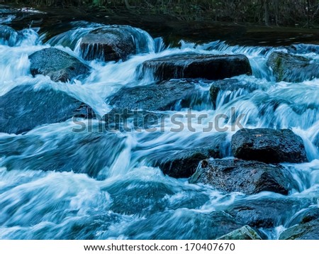 a creek with rocks and running water. landscape experience in nature.
