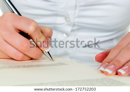 hand with fountain pen signing contract. sign woman while