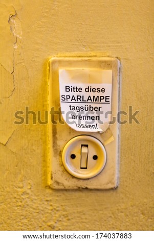 old light switch with label, let it burn saving lamp daytime